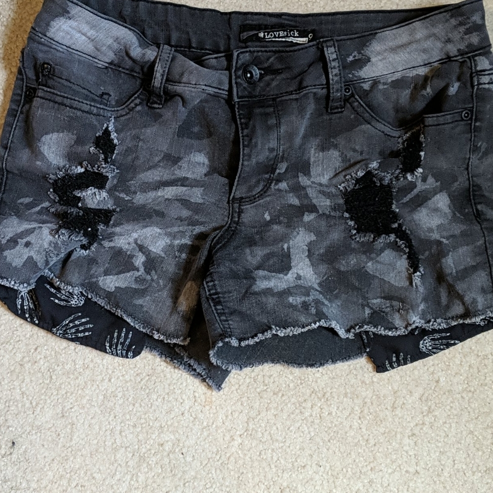 Distressed camo shorts with peekaboo pockets